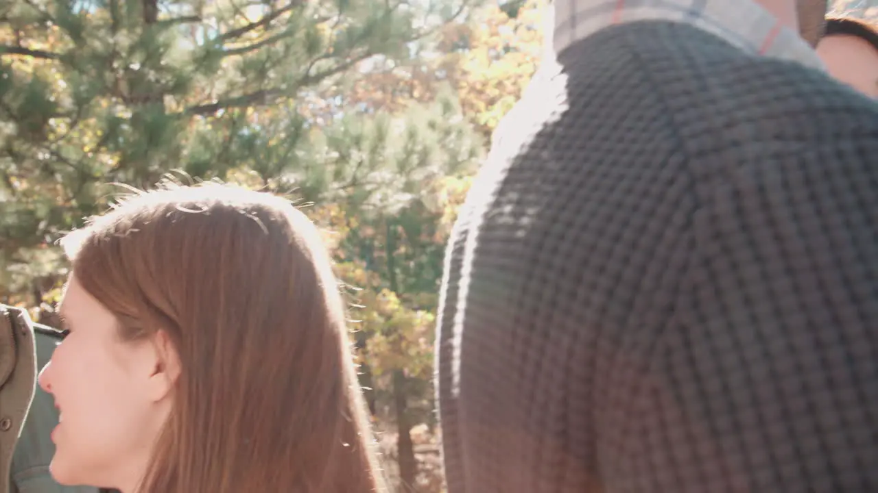 Handheld close up of friends talking outside at a barbecue