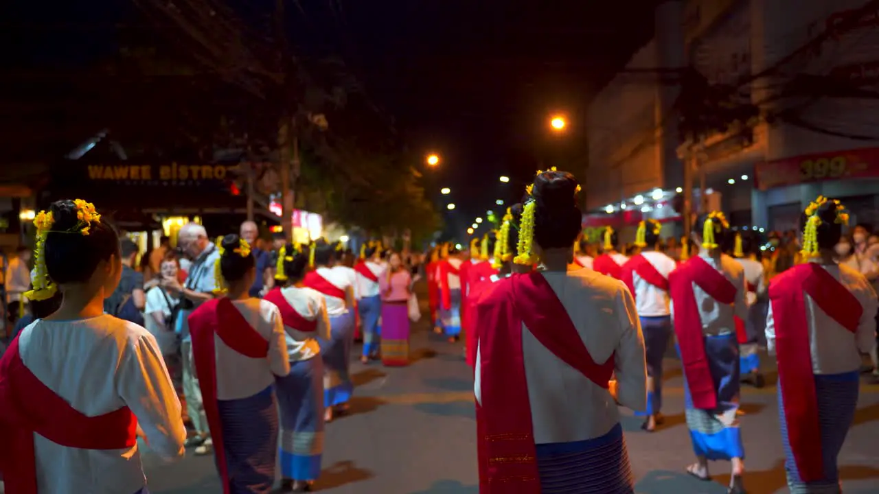 POV walking with women during traditional Yi Peng Parade in Thailand