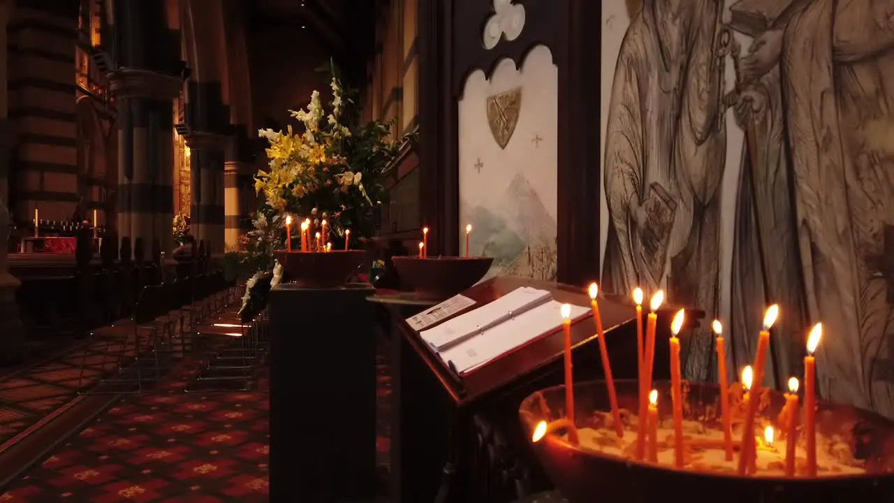 Lit candles burning in a cathedral