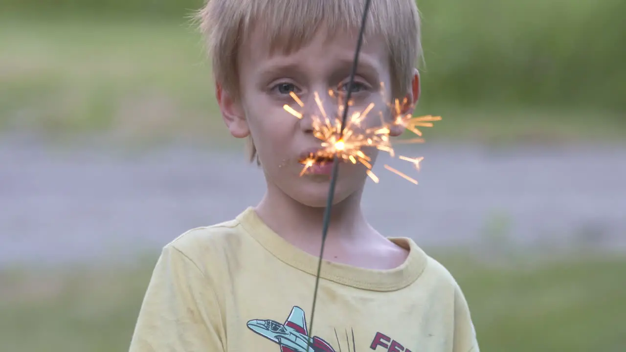 Cute little boy holding a sparkler