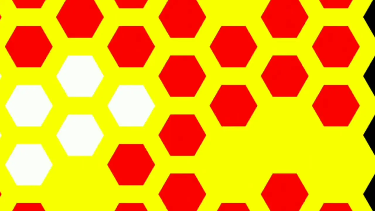 Computerized animation of small red white and black hexagons fading and popping on yellow background