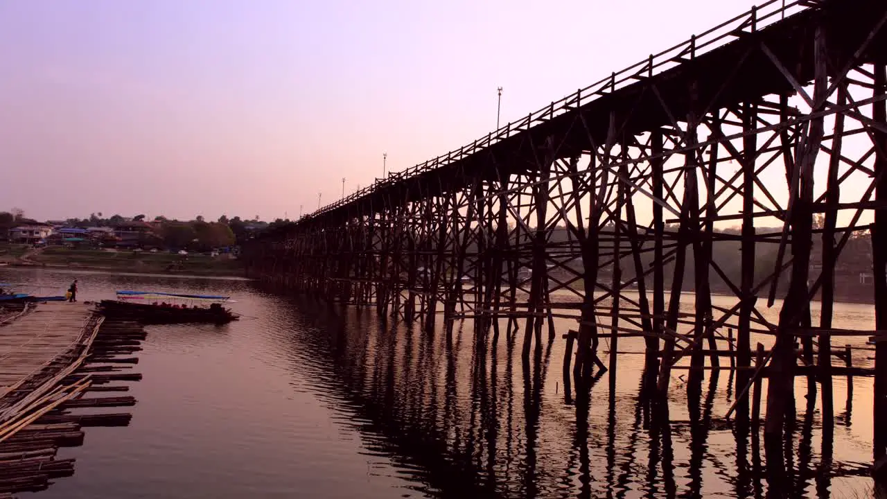 Man-made wooden long bridge for crossing back and forth at Songkla Buri Thailand during Sunset