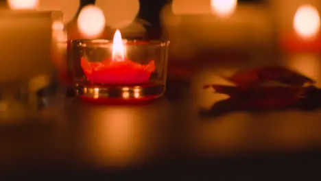 Close Up Of Romantic Lit Red And White Candles Burning On Black Background With Bokeh Lighting 5