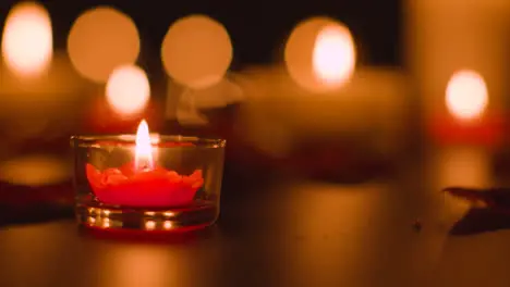 Close Up Of Romantic Lit Red And White Candles Burning On Black Background With Bokeh Lighting 3