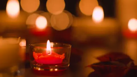 Close Up Of Romantic Lit Red And White Candles Burning On Black Background With Bokeh Lighting 4