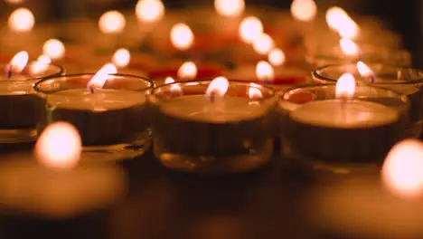 Close Up Shot Of Romantic Red And White Candles In the Shape Of A Heart On Black Background