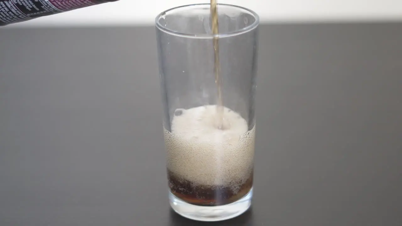 Filling up a clear glass with Soda