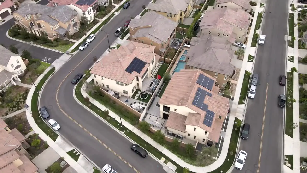 Aerial circling over Tustin houses with solar panels installed on top of roof