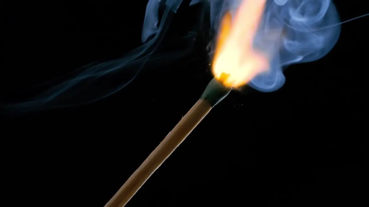 Burning matchstick close-up on a dark background Shot on super slow motion camera 1000 fps