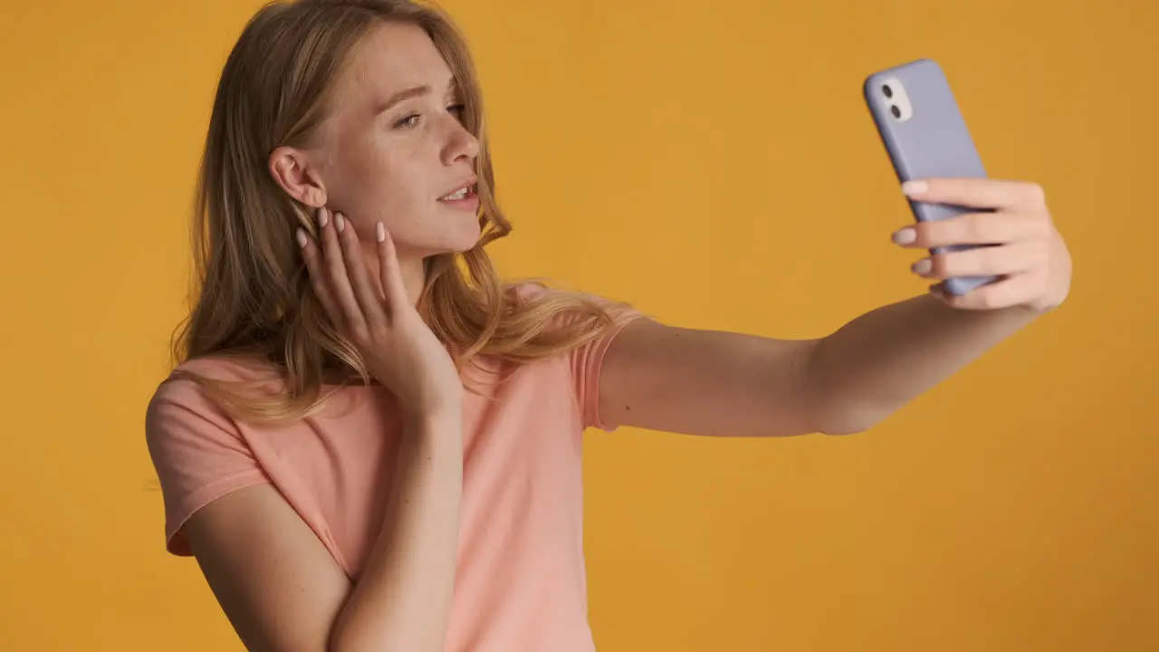 Caucasian woman taking selfies on smartphone