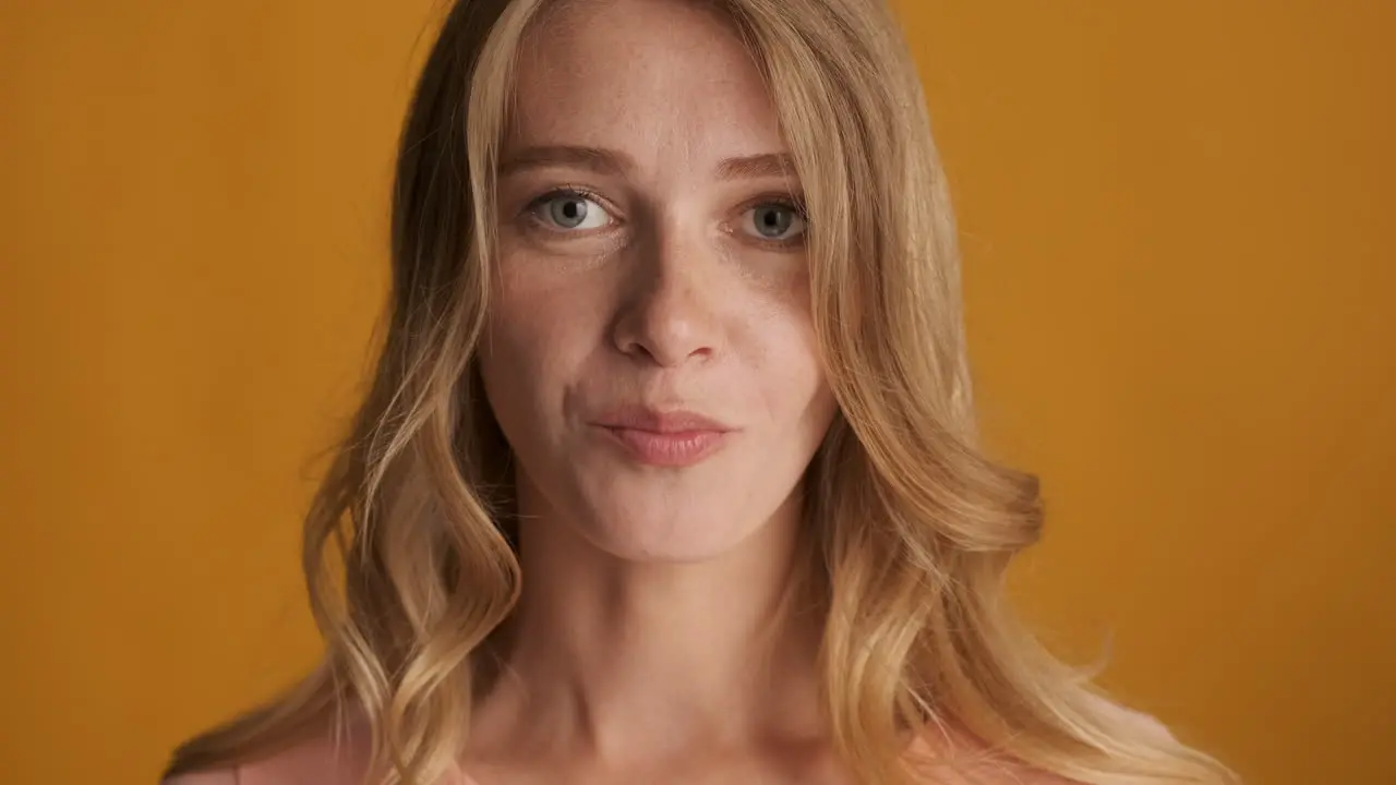 Caucasian woman chewing gum on camera