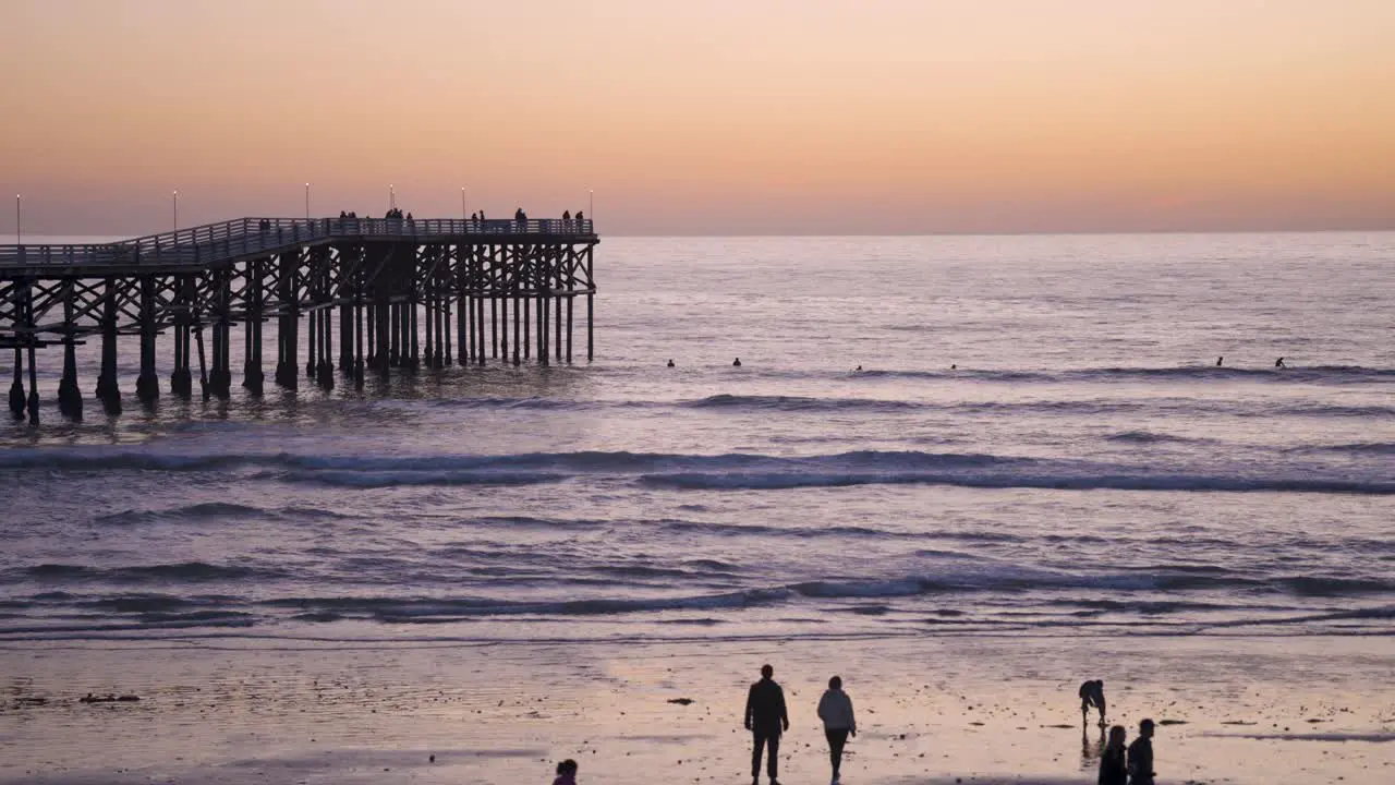 Pacific Beach California Pier Sunset with Waves Crashing on Beach slow motion of pier in blue hour