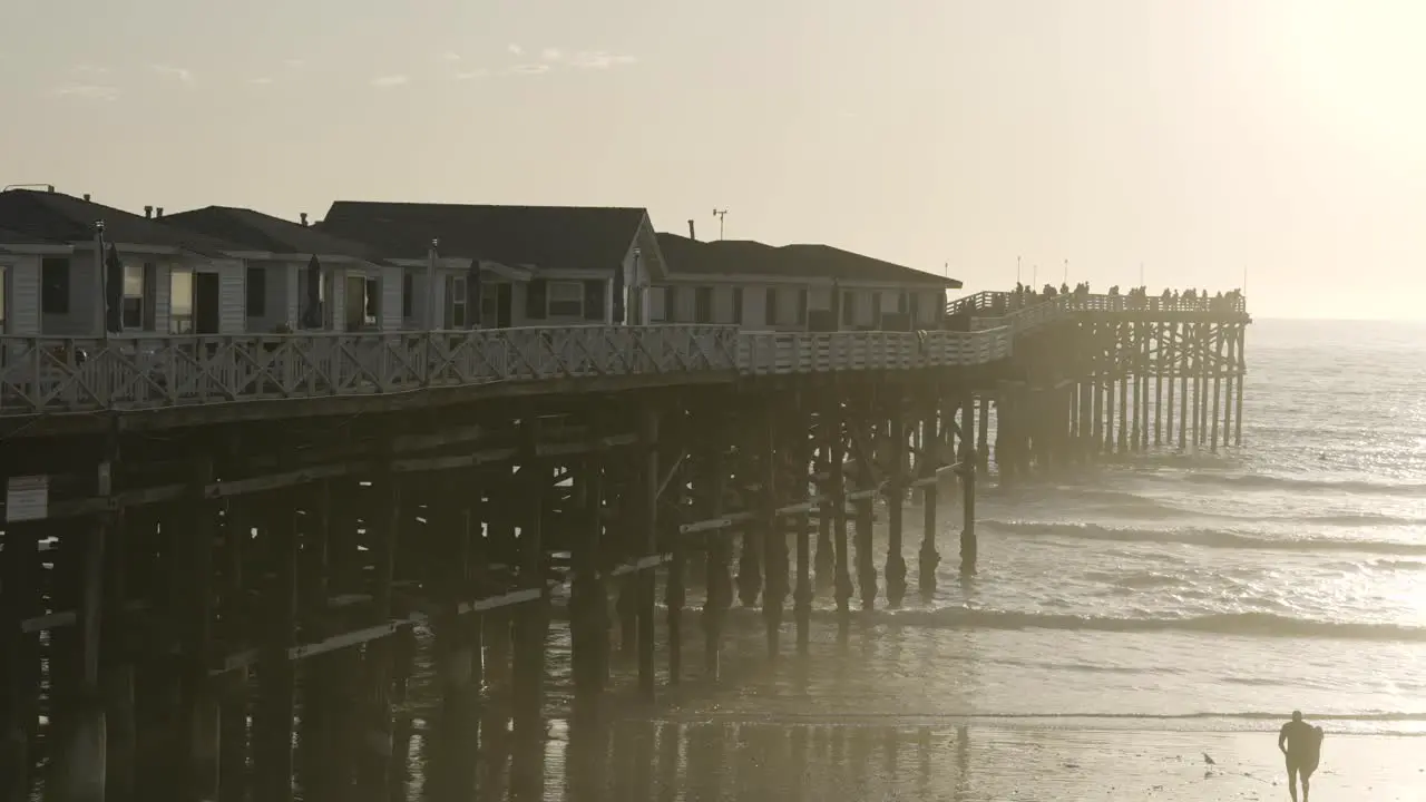 Pacific Beach California Pier Sunset with Waves Crashing on Beach Slow Motion from right side of Pier