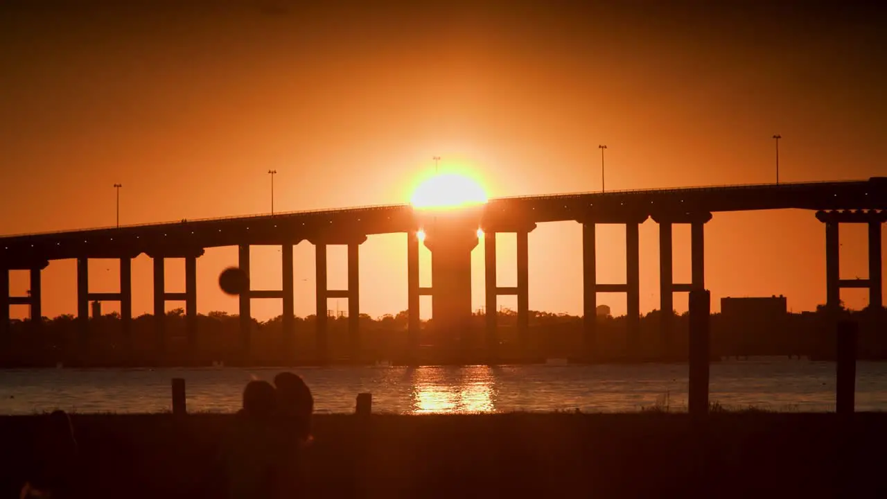 A beautiful tropical sunset on a beach above large bridge