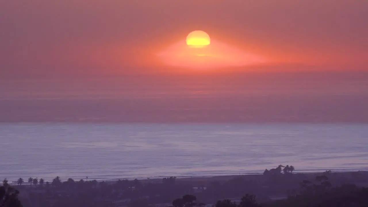 Time Lapse Of A Huge Red Round Ball Of Sun Setting At Sunset Over The Pacific Ocean Near Malibu California