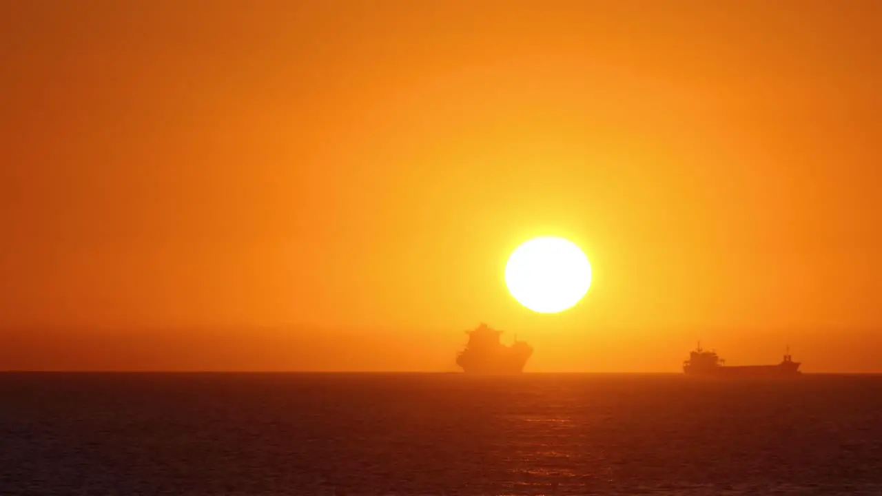 Boats floating on the sea at sunset in Atlantic sea