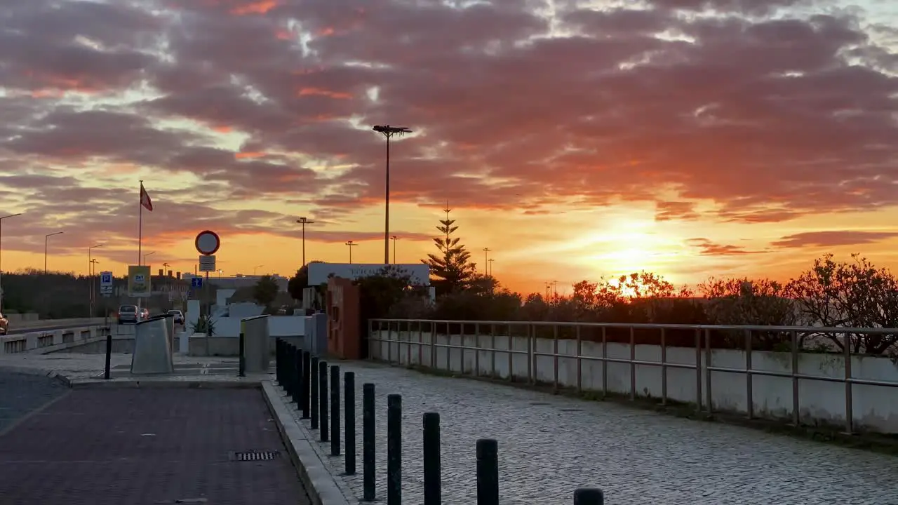 Amazing view of Cascais coastline with clouds over orange sky at dusk