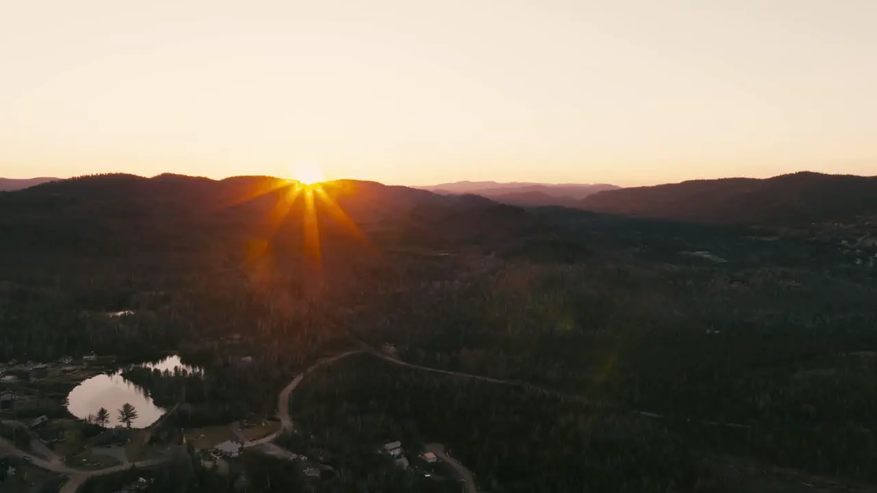 Warm Yellow Sunset Rays Over Mountain Silhouette And Valley With Road Trails At Saint-Come Quebec Canada