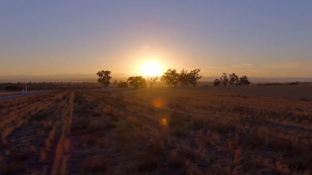 Driving along a road in California's Central Valley near King City while watching a spectacular sunrise passenger point of view