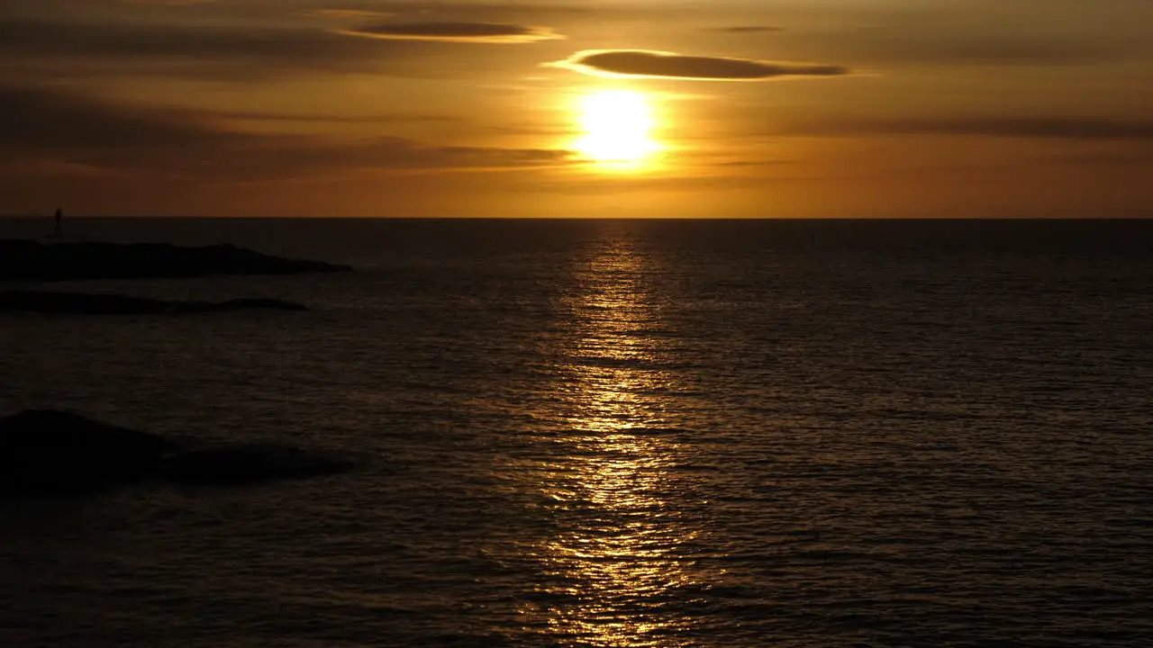 Static shot of sunrise above the Skagerrak sea on Justoya island on a sunny morning in Aust-Agder Norway