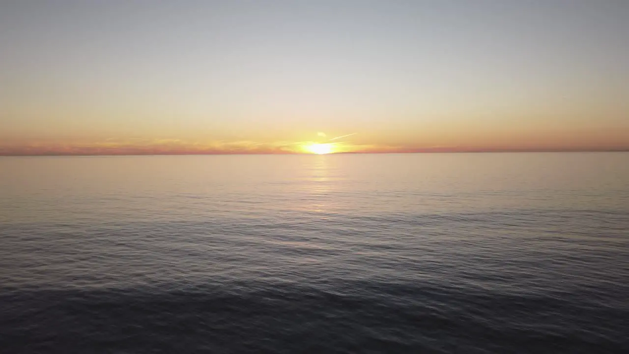 A beautiful aerial drone shot drone flying towards the sun during golden hour Carlsbad State Beach California