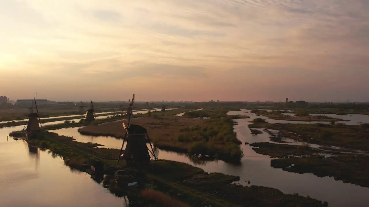 drone shot slowly rotating to the left at the windmills of Kinderdijk at sunset in 4K