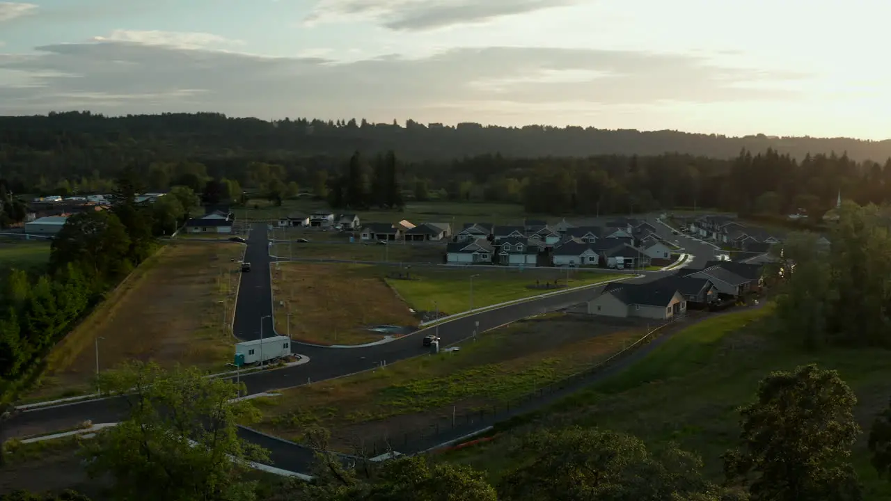 Drone shot with a smooth camera pan of a small town at sunset