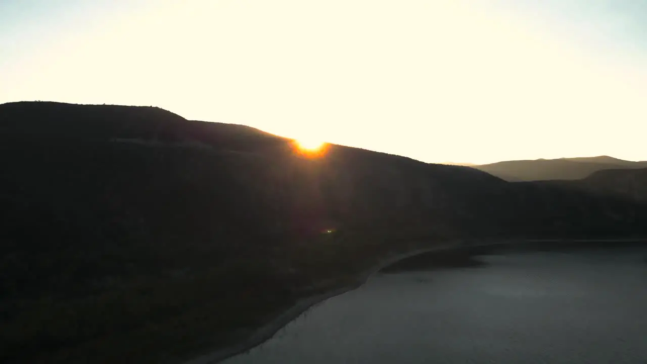 drone flying over Mountain to reveal setting sun  vail lake Temecula