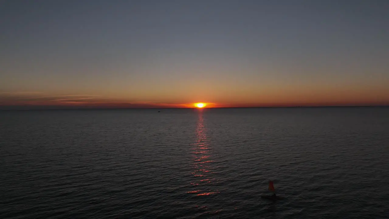 Aerial reverse reveal of sunset over Mobile Bay Alabama