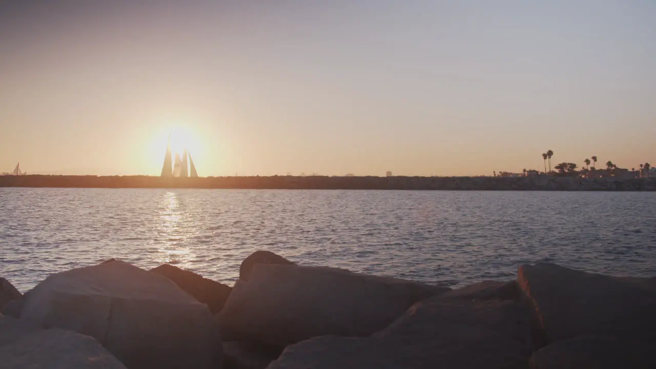 Sailboats against a Pacific sunset