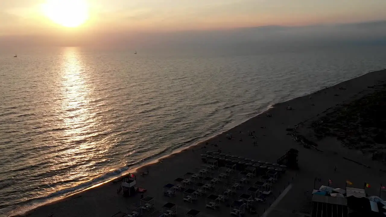 Ascending drone shot of sunset over the sea