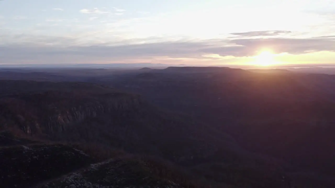 Aerial shot of rolling hills during sunrise on a beautiful day