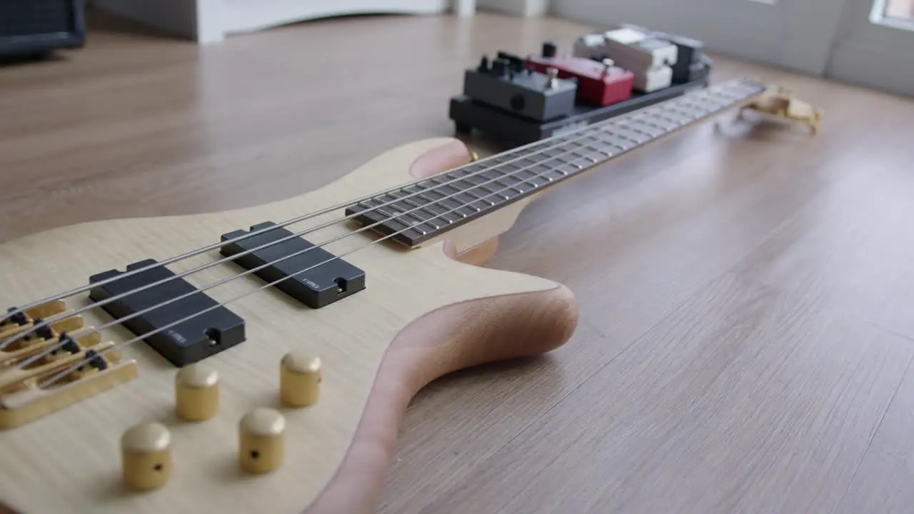 Close Up Dolly of a Bass Guitar and Effect Pedals