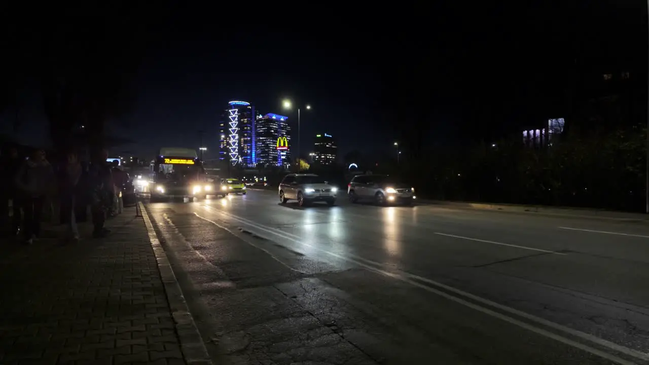 Public Bus 72 arriving to a bus stop at 'Evlogi and Hristo Georgievi Boulevard' at night and people preparing to get on