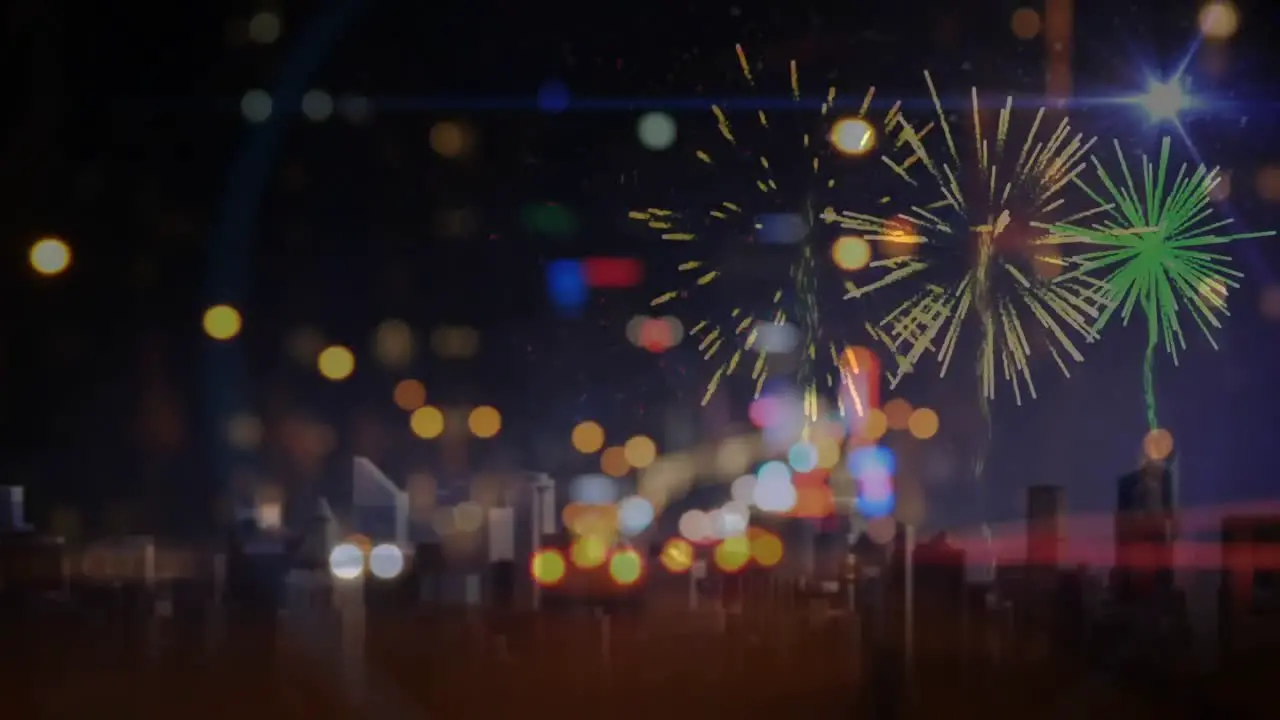 Cars driving towards fireworks on city road in the evening