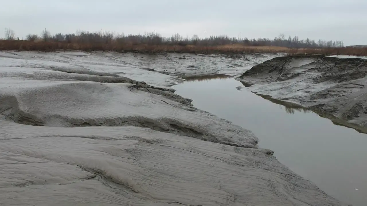 Dry land on river banks during low tide flood in aerial truck shot