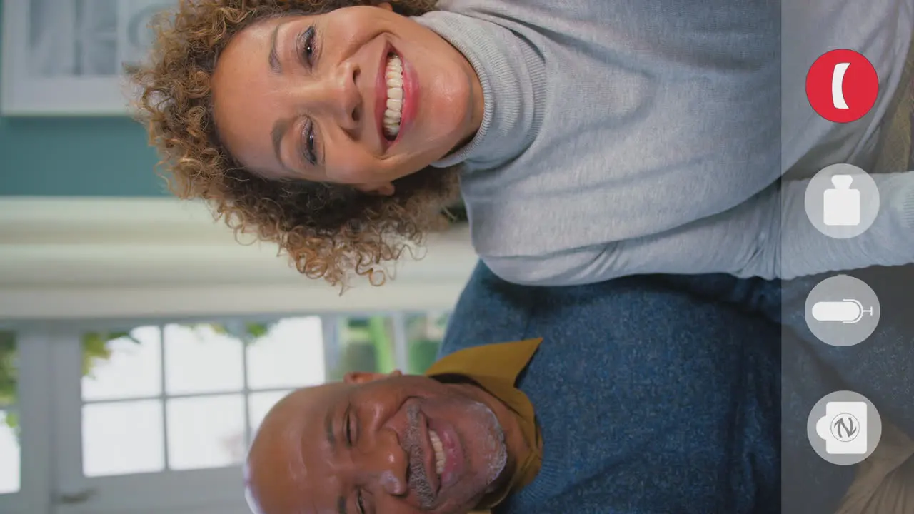 Vertical Video Showing Device Screen With Icons As Senior Couple Make Video Call