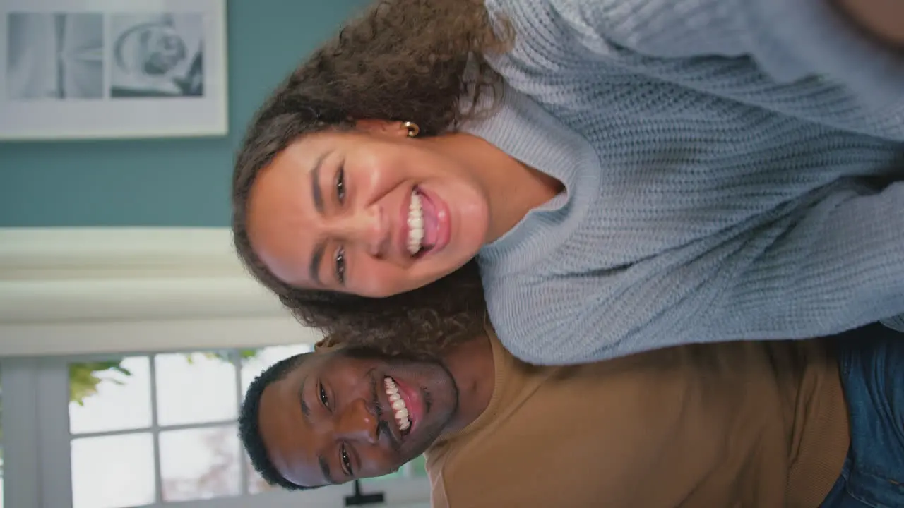 Vertical Video Showing Device Screen As Young Couple Make Video Call