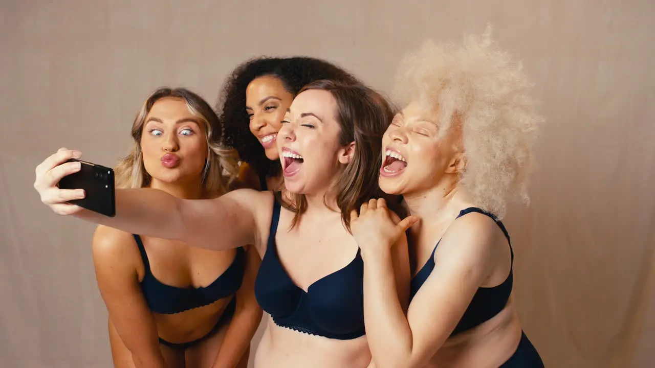 Group Of Diverse Body Positive Women Friends In Underwear Posing For Selfie On Mobile Phone