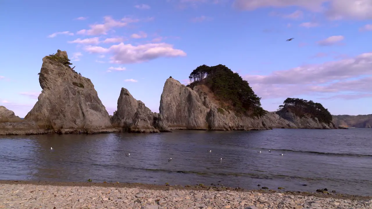 Breathtaking scenery at Jodagahama Beach in Japan with sharp cliffs changing light and seagulls