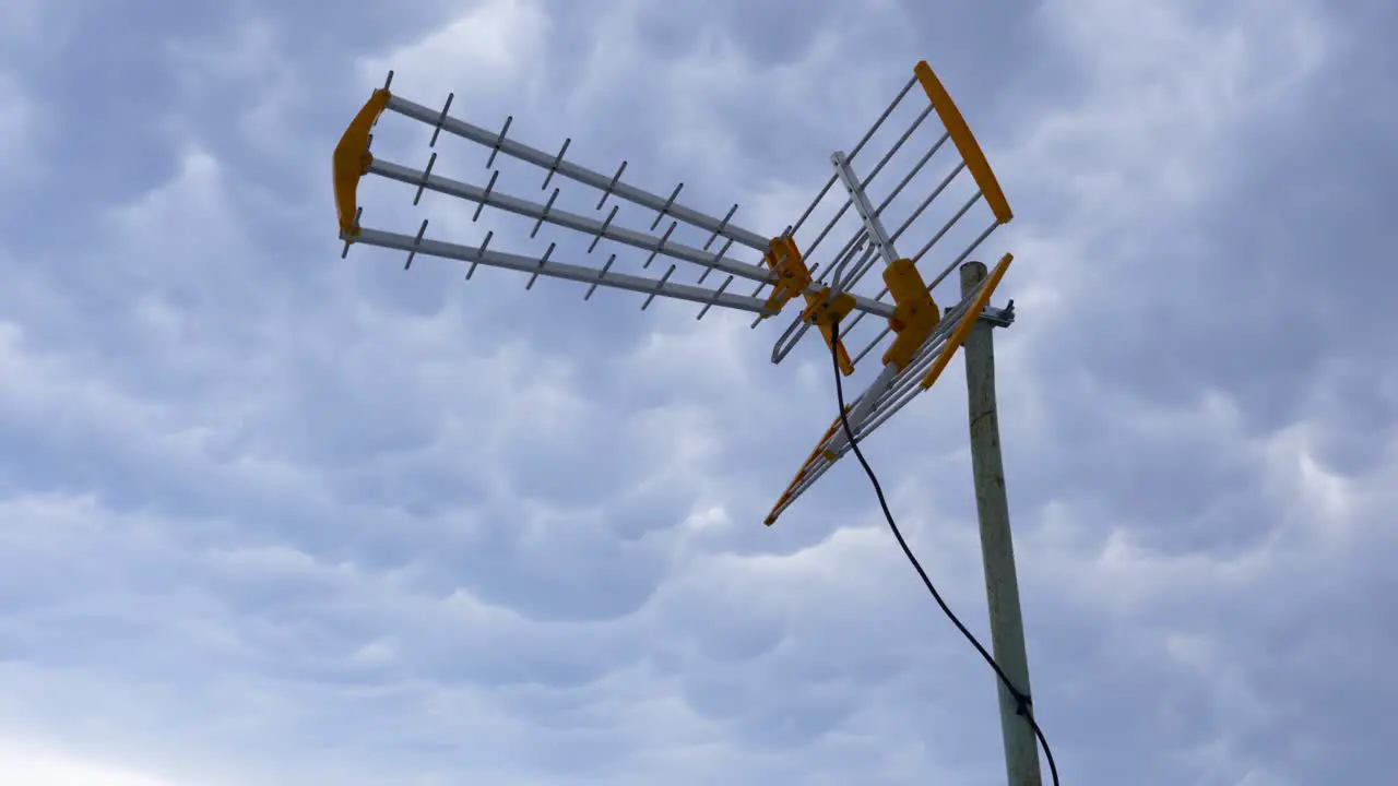 Antenna waved by wind on cloudy sky background communication wireless concept