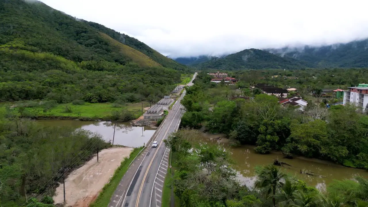 drone shoot of a Car crossing a bridge in the middle of the rain forest Brazil