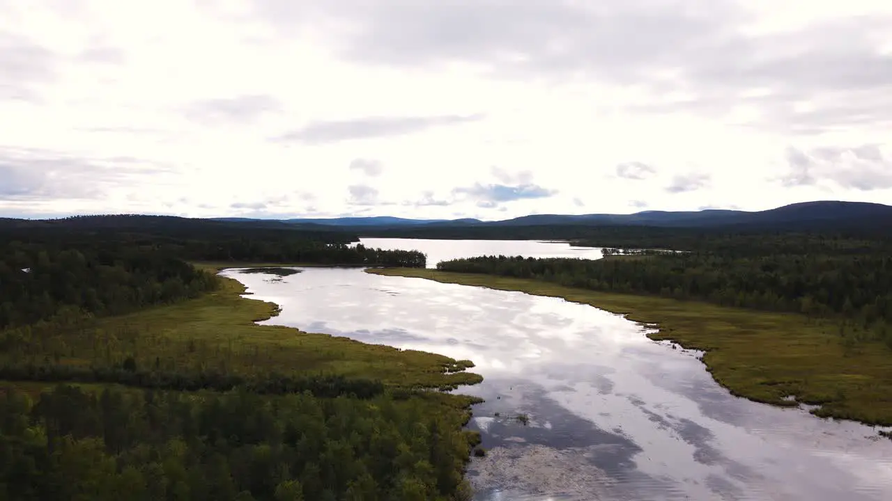 Overcasted skies lurking over Abisko National park shores Sweden aerial