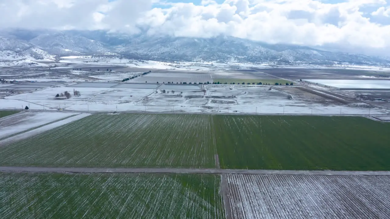 Flying over a green snowy field in the vast landscape of Tehachapi CA