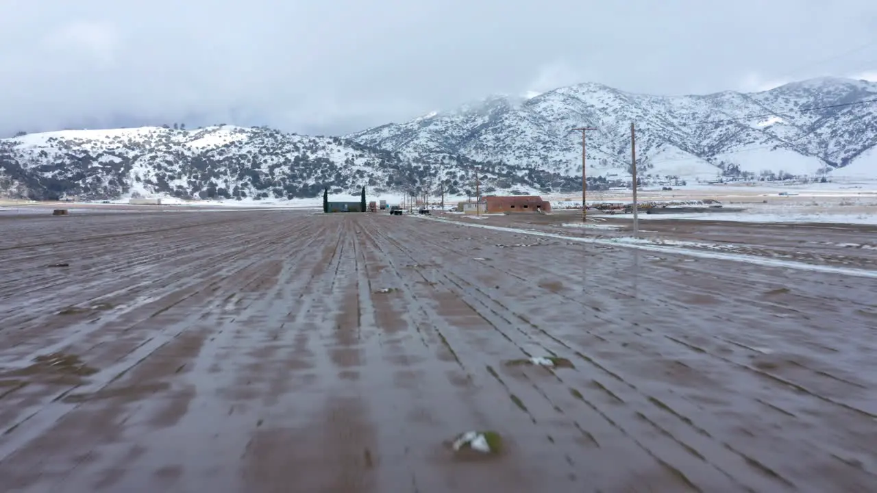 Flying toward a wintery snowy farm in Tehachapi CA