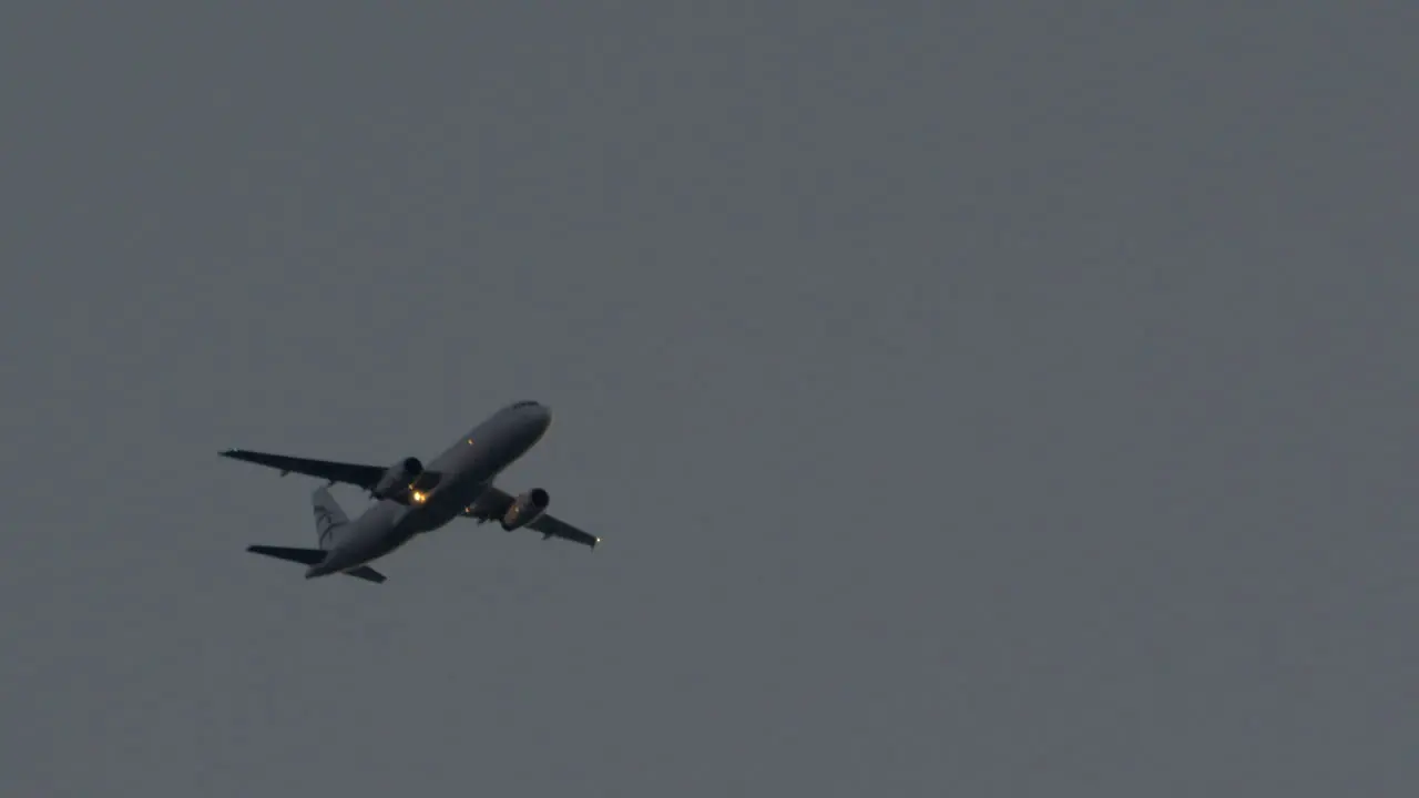 View of flying aircraft in the grey rainy sky Thessaloniki International Airport Greece