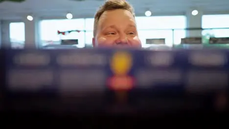 Filming in Brest and a man approaches the counter and takes a box of sweets from there A man selects a box from the counter