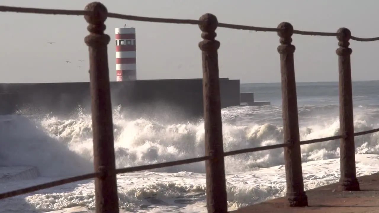 ocean big waves crash over the lighthouse frame the frame