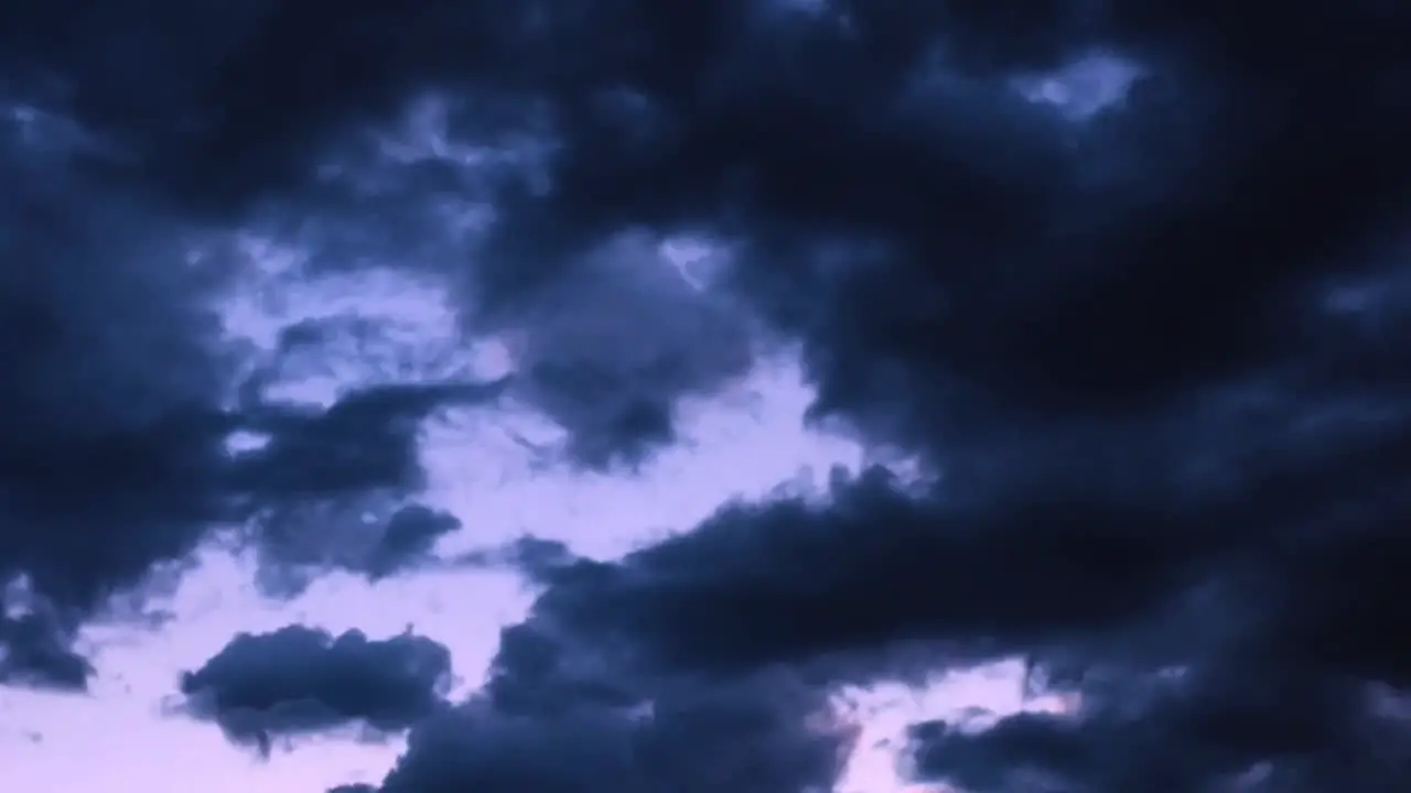 Time-lapse Monsoon storm clouds gather in the Arizona skies at sunset turning the sky purple and pink