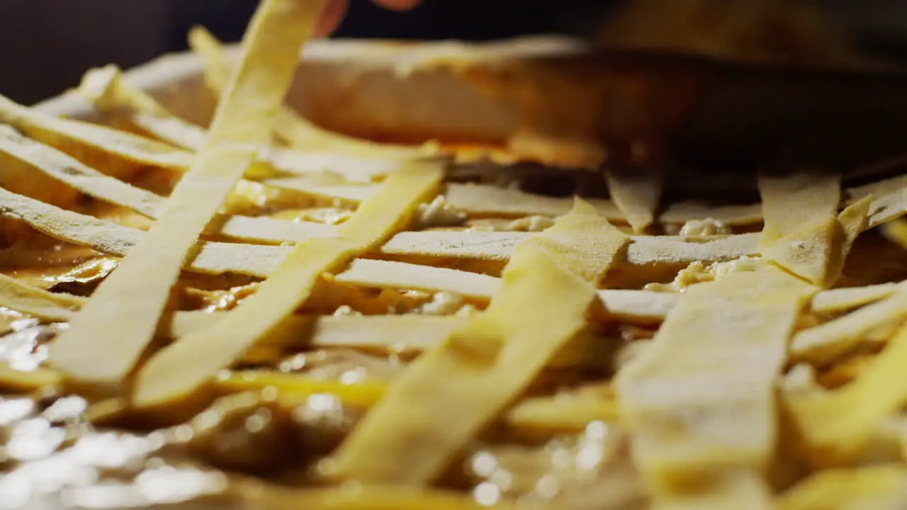 Placing uncooked yolk dough strips on the top of a lasagna step by step recipe